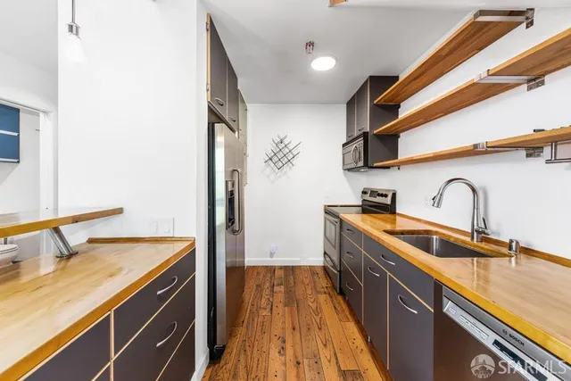 a kitchen with sink a microwave and stove