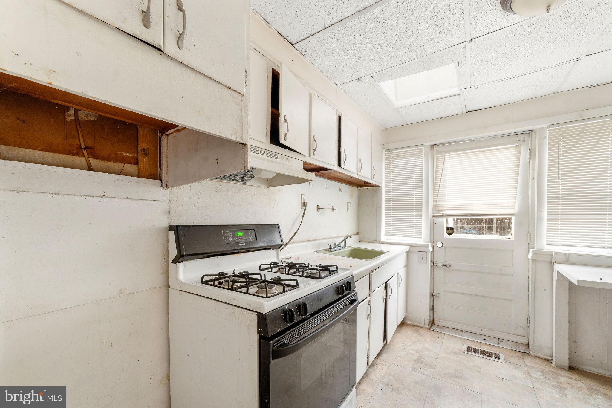 1263 South Merrimac Road Camden, NJ 08104 - Photo 11 of 21 a kitchen with a stove and a refrigerator