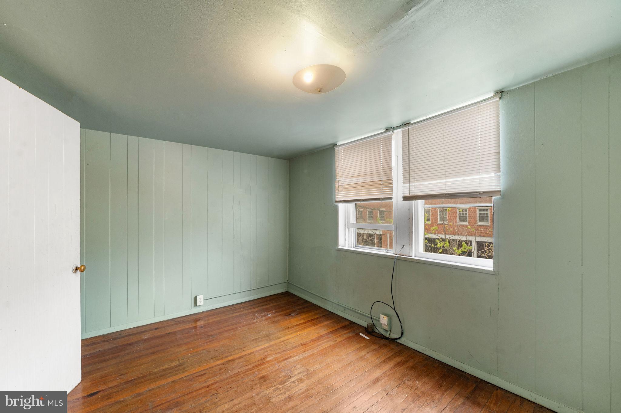 1263 South Merrimac Road Camden, NJ 08104 - Photo 15 of 21 a view of an empty room with wooden floor and a window