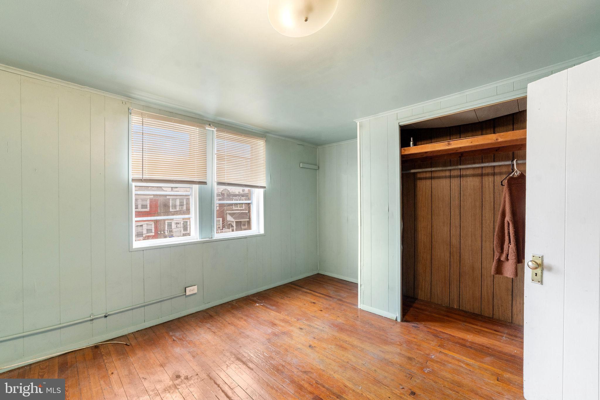1263 South Merrimac Road Camden, NJ 08104 - Photo 17 of 21 an empty room with wooden floor and windows