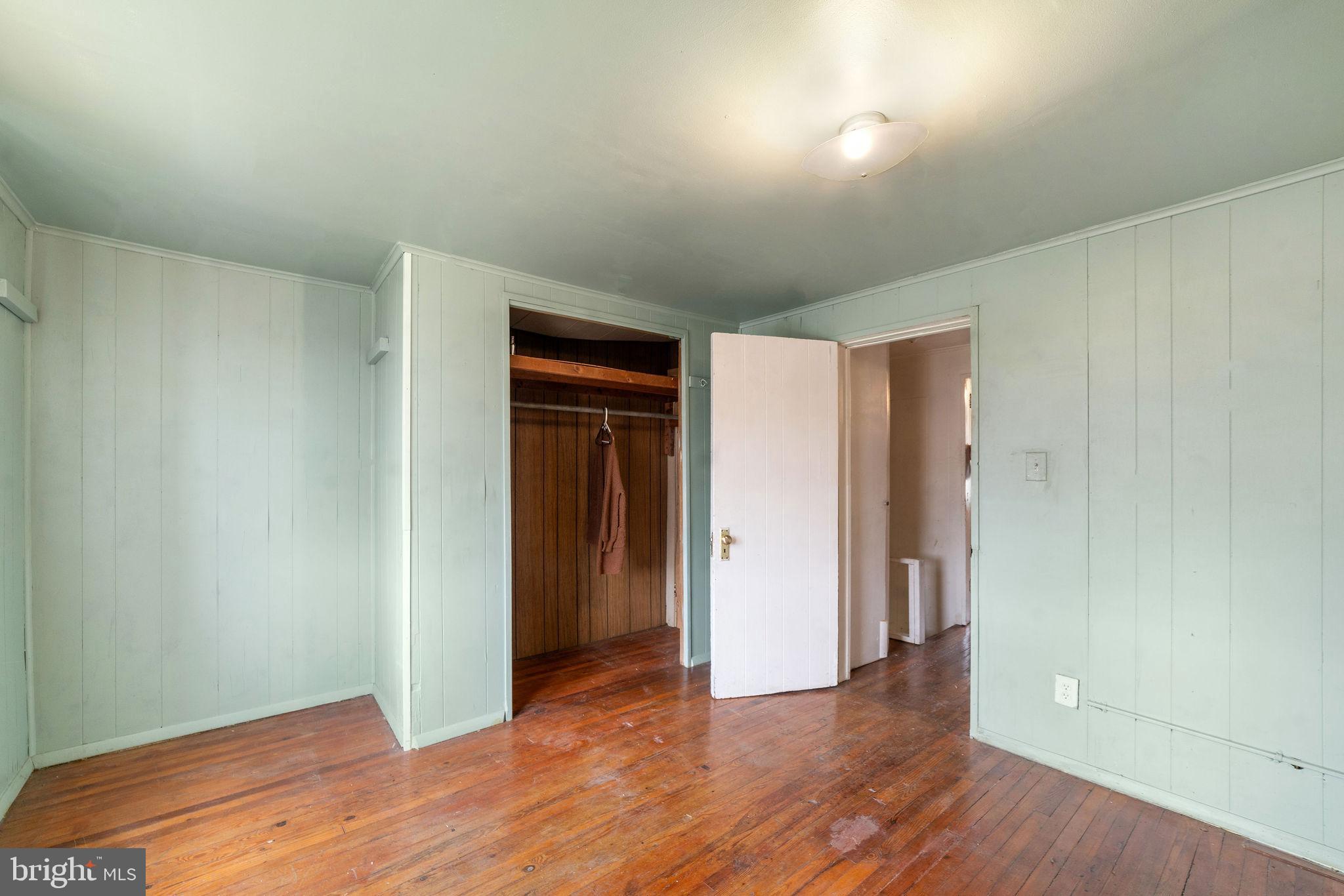 1263 South Merrimac Road Camden, NJ 08104 - Photo 18 of 21 an empty room with wooden floor and closet