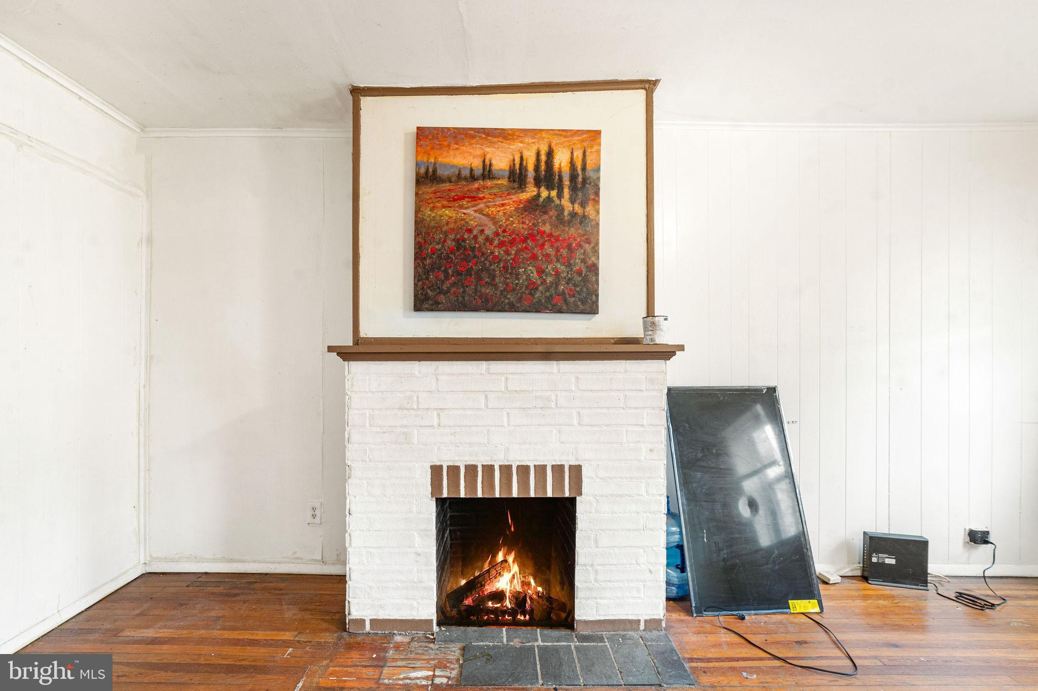 1263 South Merrimac Road Camden, NJ 08104 - Photo 6 of 21 a living room with a fireplace and wooden floor