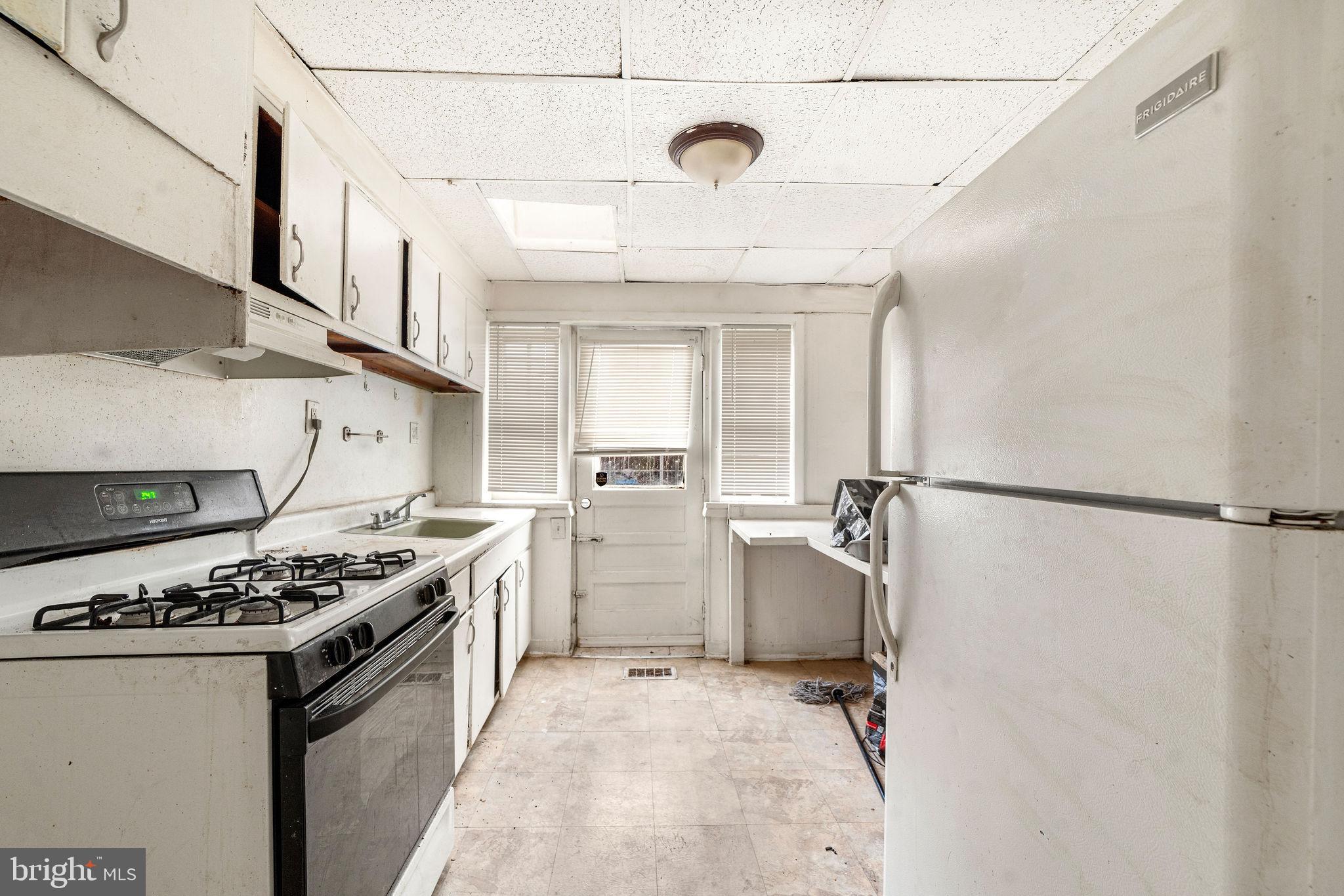 1263 South Merrimac Road Camden, NJ 08104 - Photo 10 of 21 a kitchen with a stove and a refrigerator