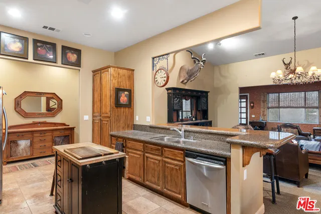 a kitchen that has a sink a stove and a wooden floor