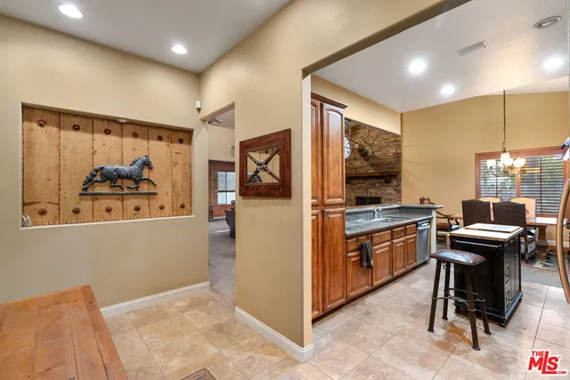 a view of a workspace with furniture and a kitchen