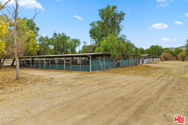 a swimming pool with trees in the background