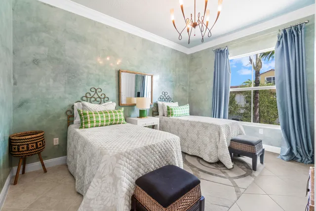 a bedroom with a bed and a chandelier