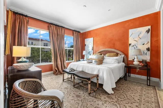 a bedroom with a bed and a large window