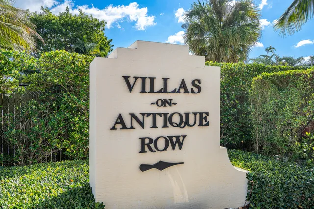 a sign that is sitting on a brick wall