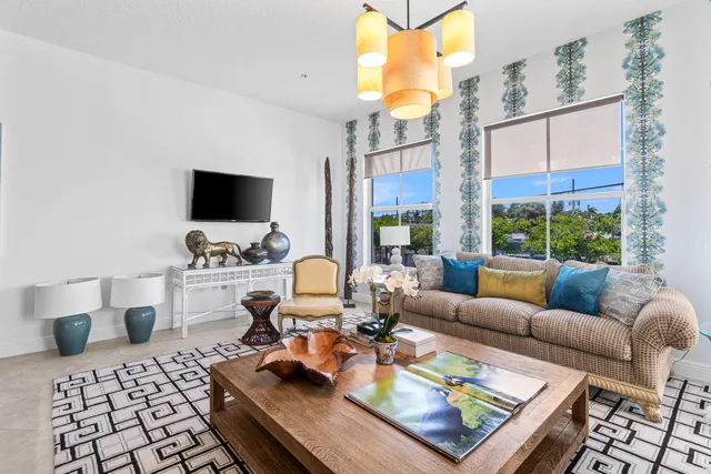 a living room with furniture a rug and a window
