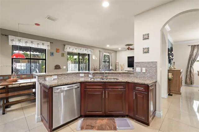 a kitchen with stainless steel appliances granite countertop a refrigerator oven a sink and dishwasher