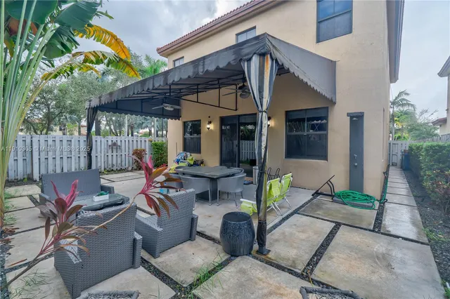 a view of a patio with a table chairs and a backyard