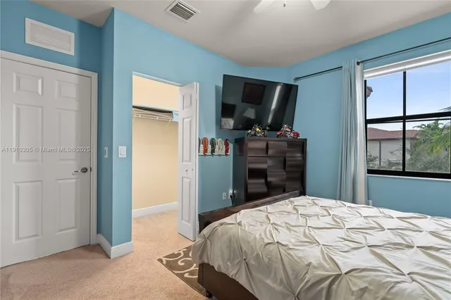 a bedroom with a large bed and a window