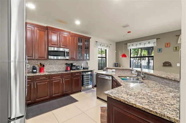 a kitchen with granite countertop a sink and cabinets