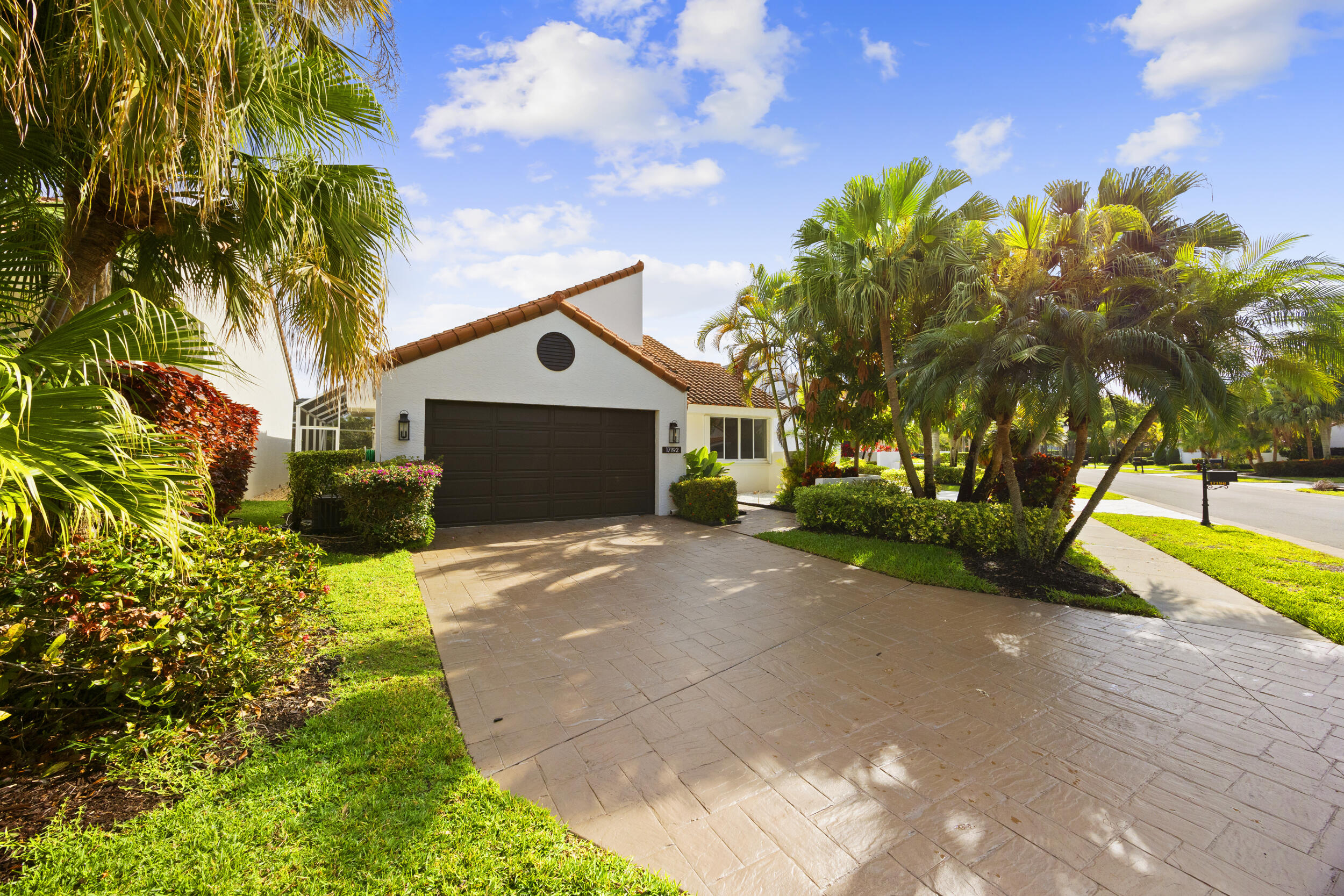 17192 Newport Club Drive Boca Raton, FL 33496 - Photo 1 of 72 a front view of a house with a yard and garage