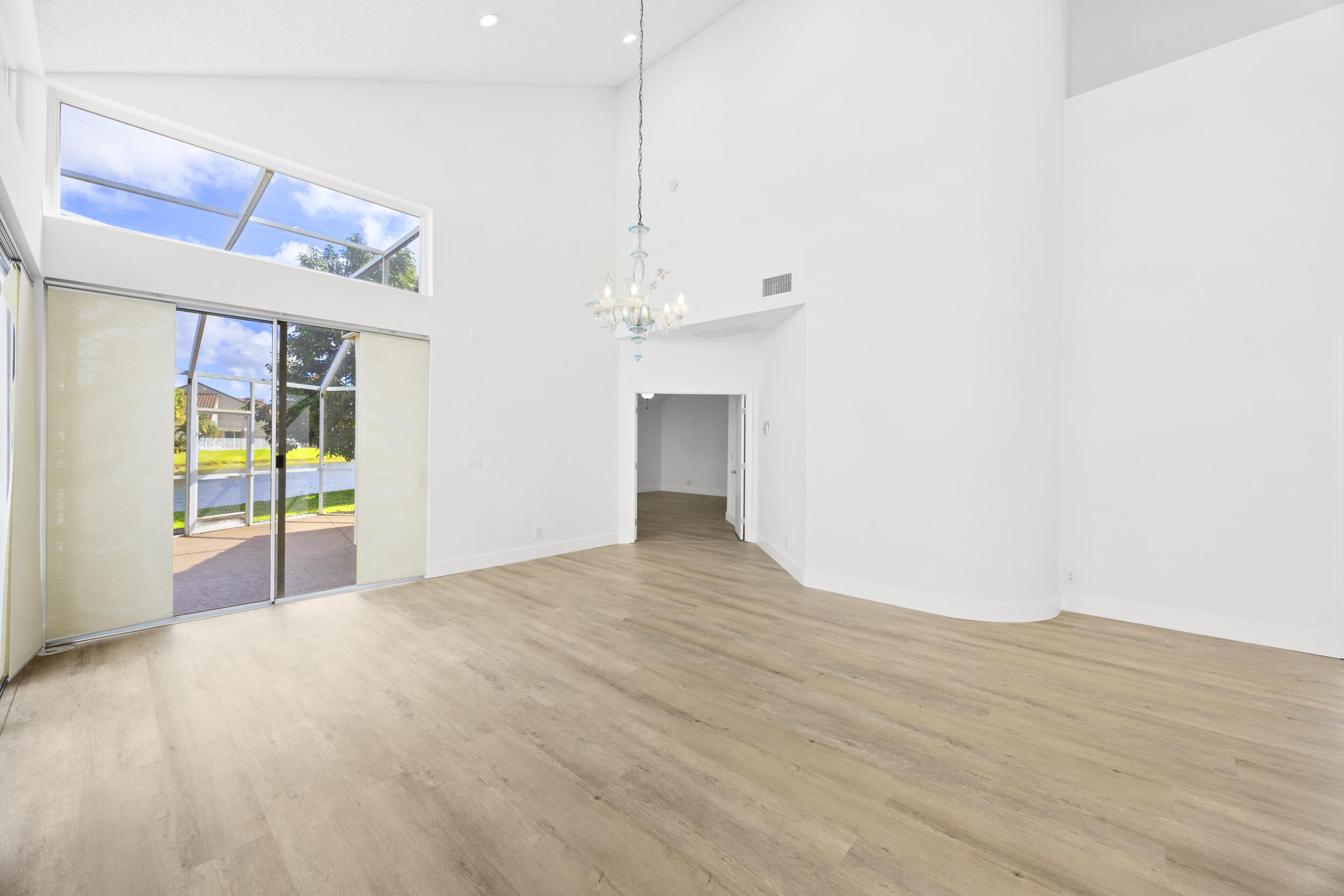17192 Newport Club Drive Boca Raton, FL 33496 - Photo 19 of 72 a view of empty room with wooden floor and fan