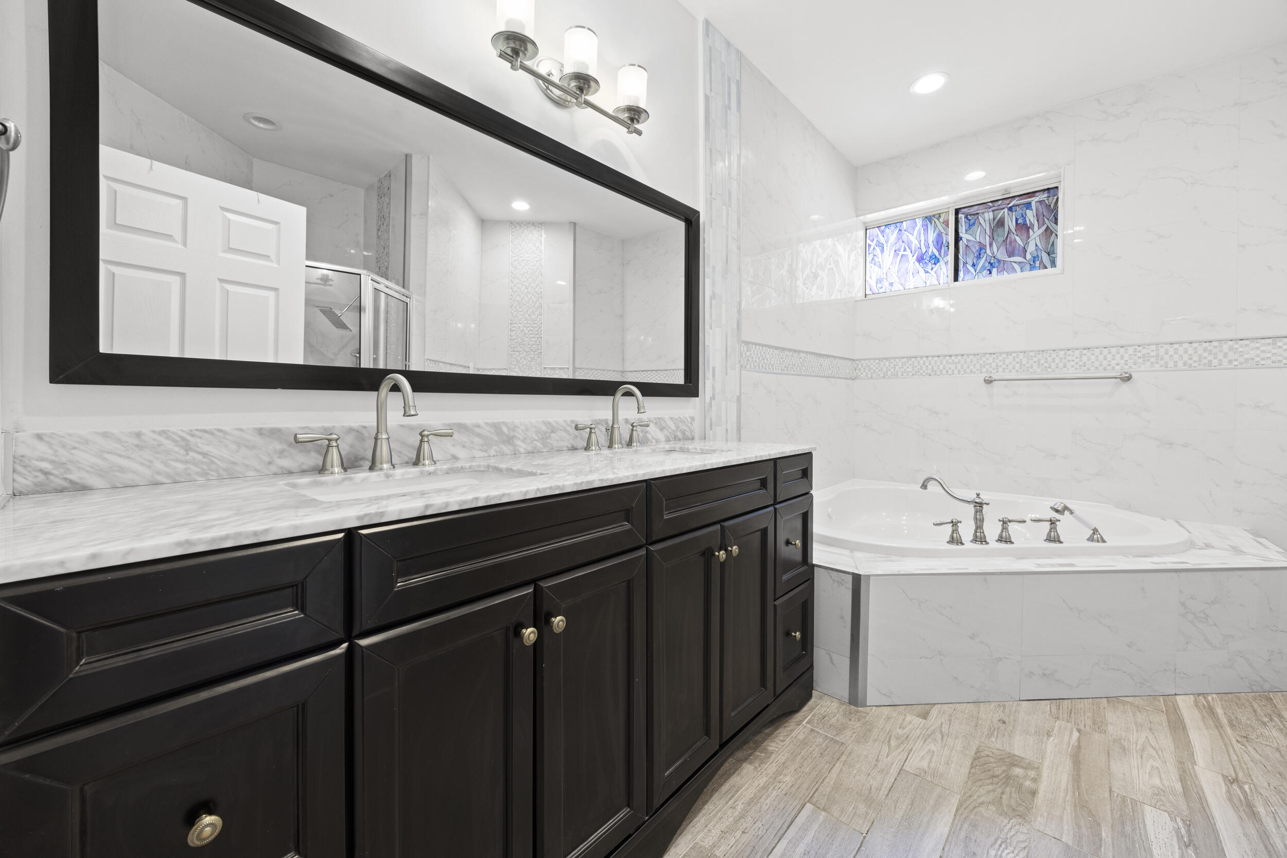 17192 Newport Club Drive Boca Raton, FL 33496 - Photo 29 of 72 a bathroom with a double vanity sink and a mirror