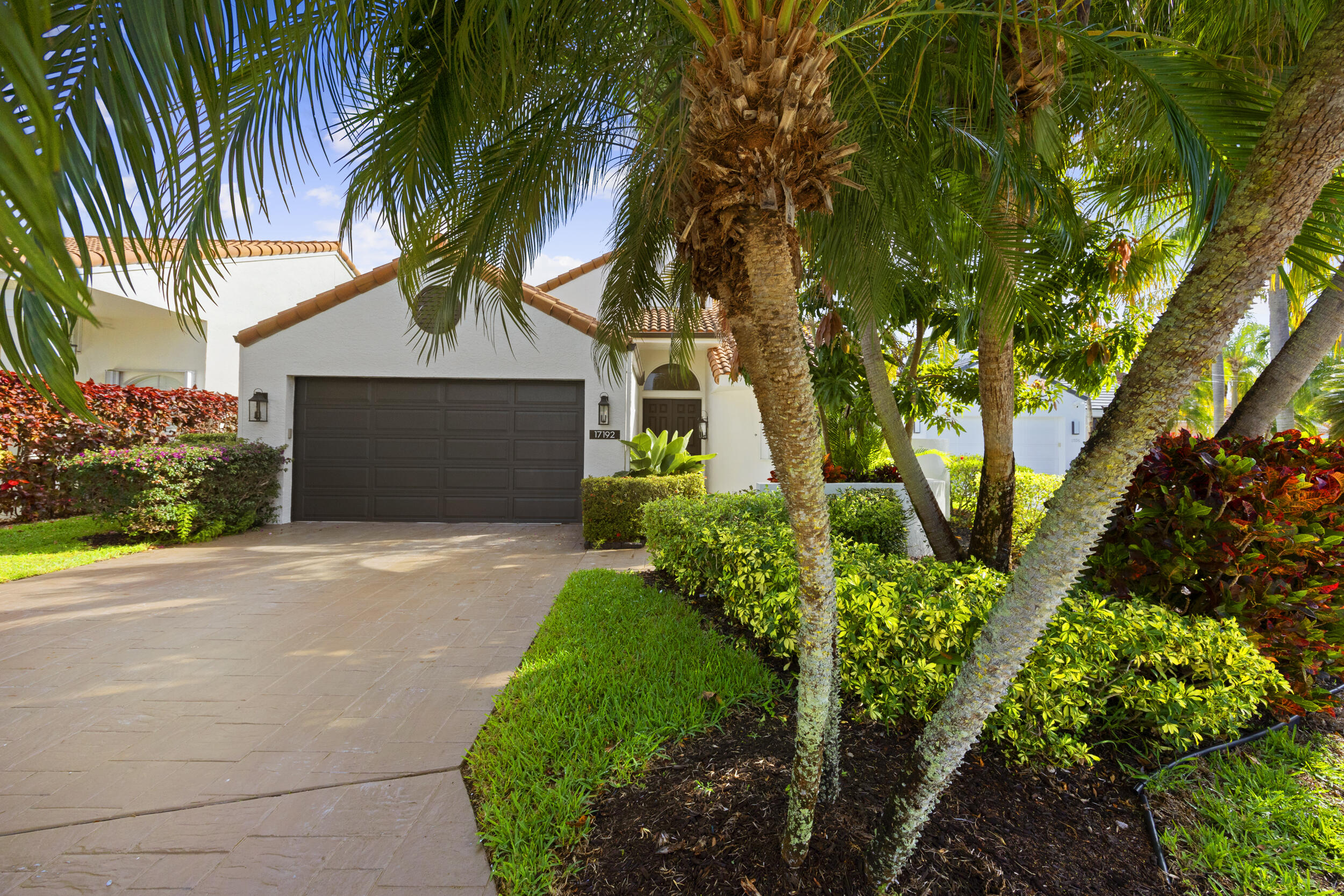17192 Newport Club Drive Boca Raton, FL 33496 - Photo 3 of 72 a front view of a house with a garden