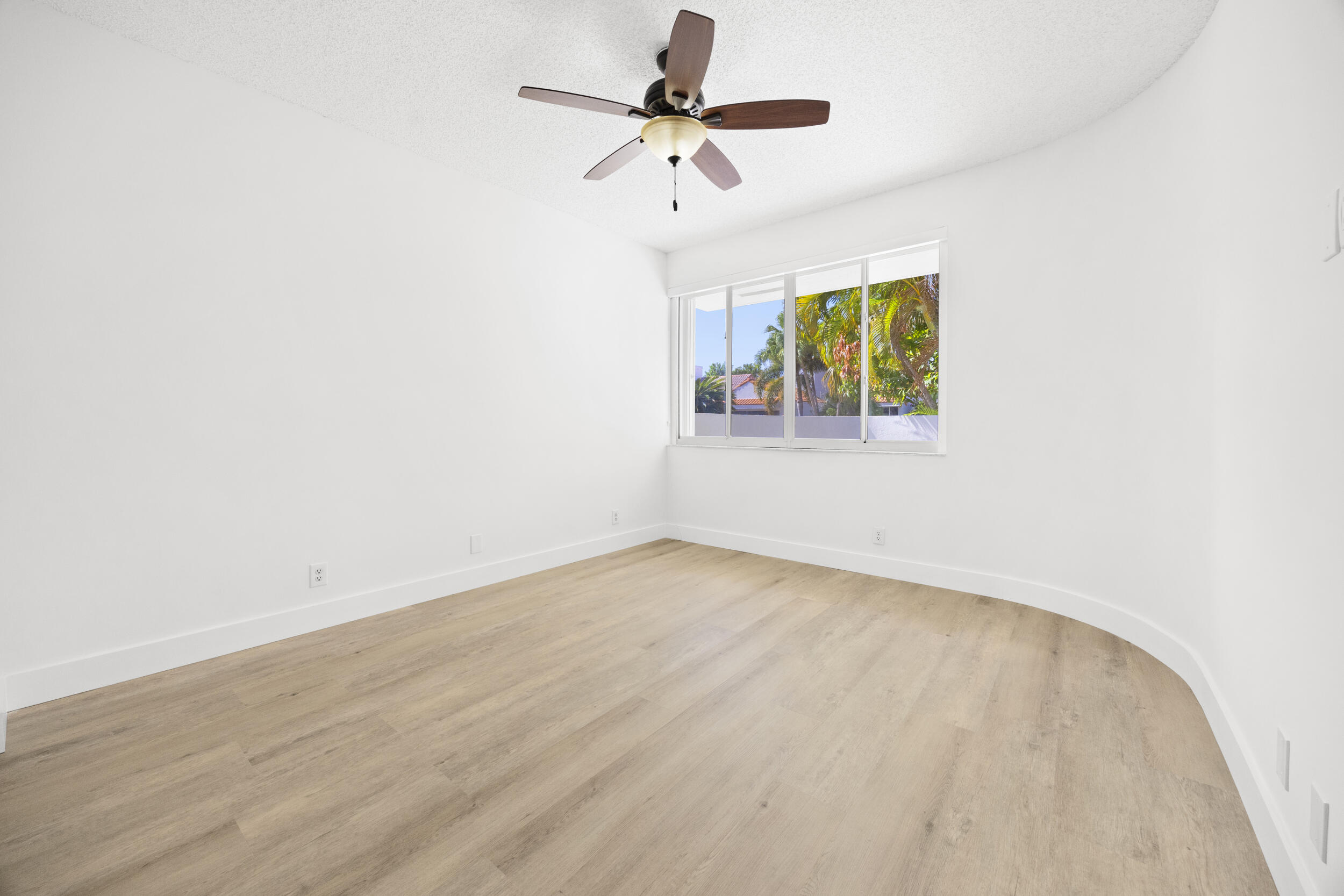 17192 Newport Club Drive Boca Raton, FL 33496 - Photo 38 of 72 an empty room with a window and a ceiling fan