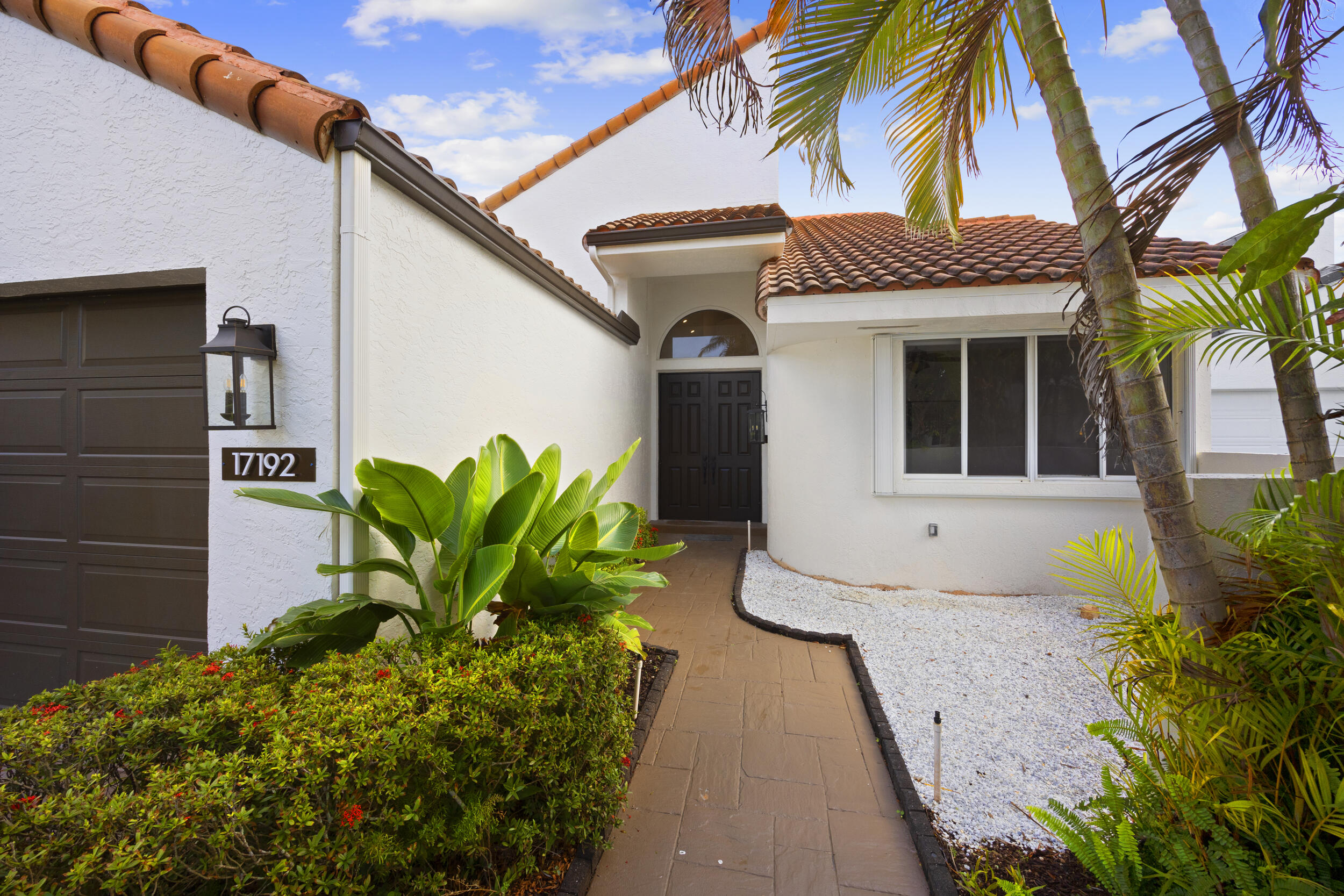 17192 Newport Club Drive Boca Raton, FL 33496 - Photo 4 of 72 a front view of a house with a yard