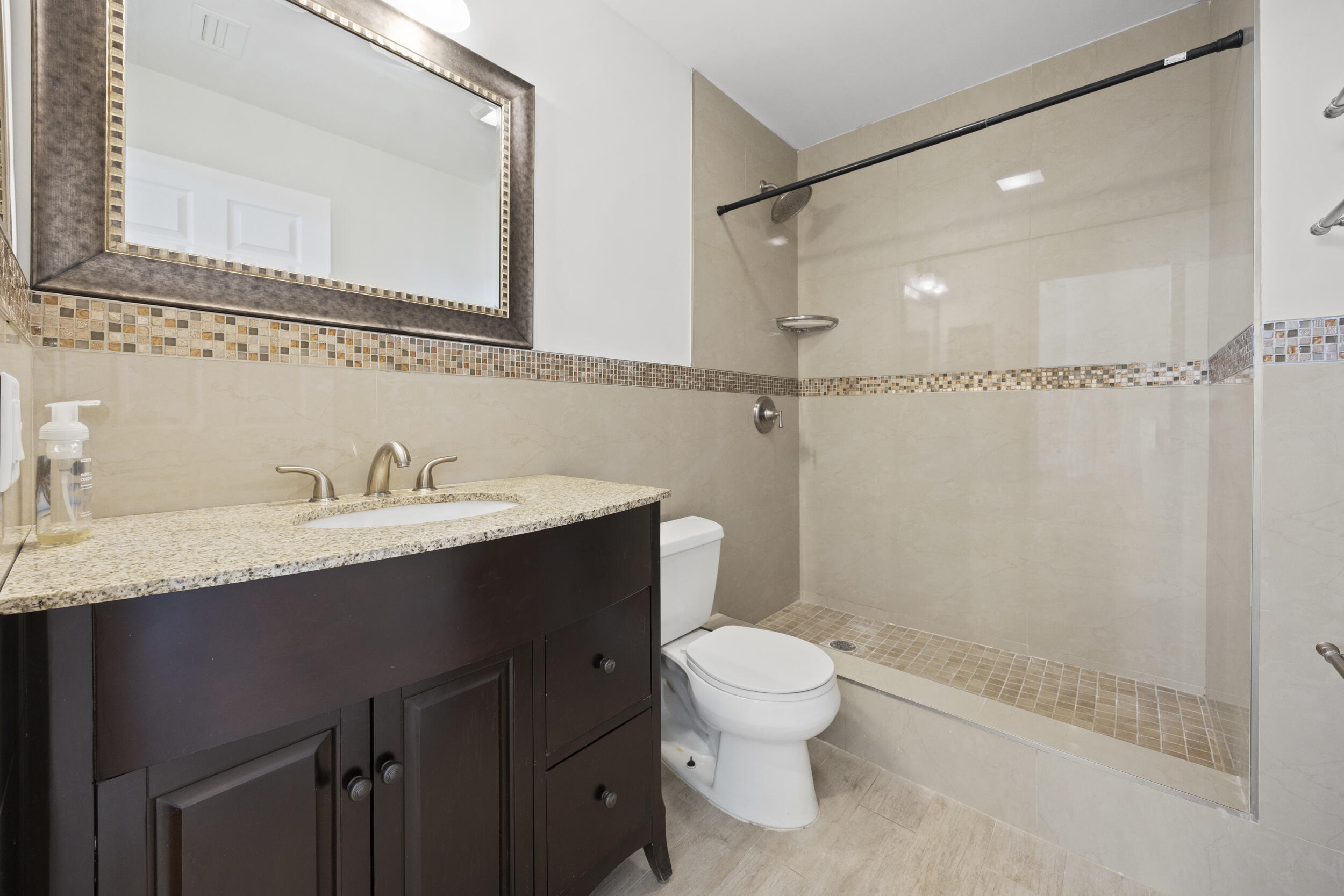17192 Newport Club Drive Boca Raton, FL 33496 - Photo 42 of 72 a bathroom with a granite countertop sink toilet and shower