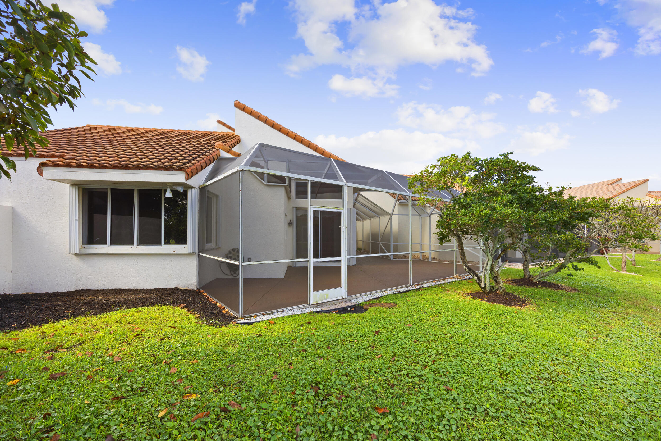 17192 Newport Club Drive Boca Raton, FL 33496 - Photo 49 of 72 a backyard of a house with plants and wooden fence