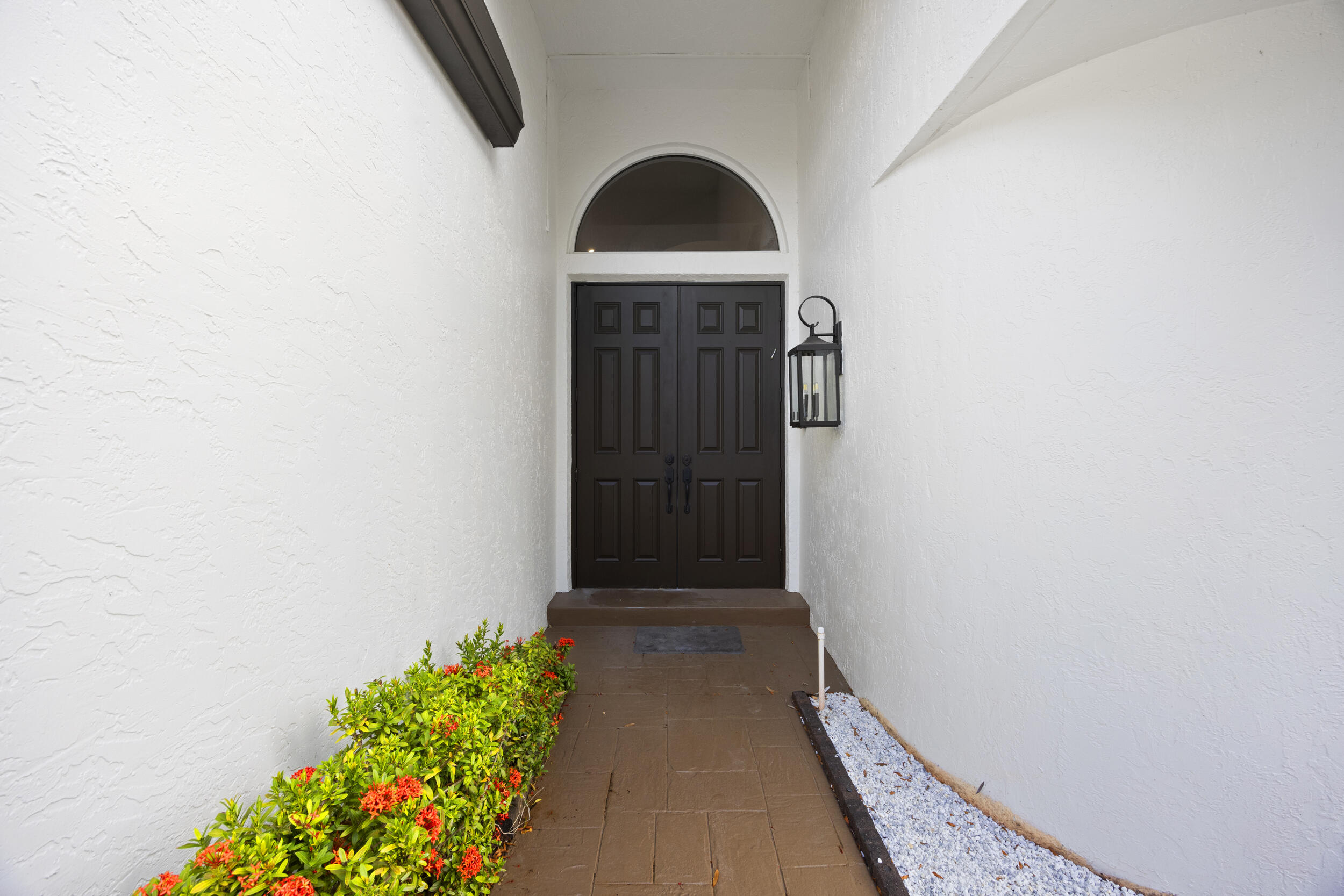 17192 Newport Club Drive Boca Raton, FL 33496 - Photo 5 of 72 a view of a hallway with wooden floor and a potted plant