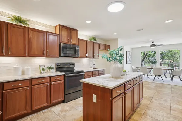 a kitchen with granite countertop a sink and a stove