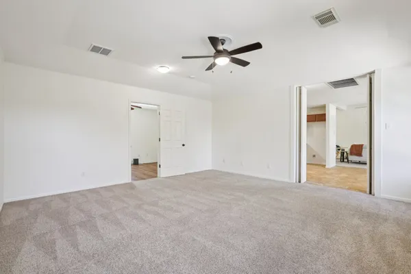 a view of a big room with wooden floor and windows in a room