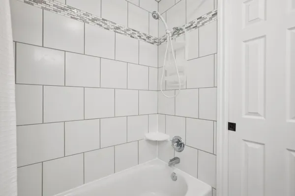 a bathroom with a bathtub and shower