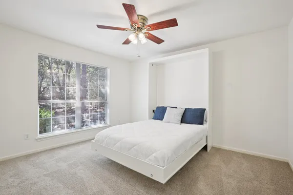 a bedroom with a large bed and a large window