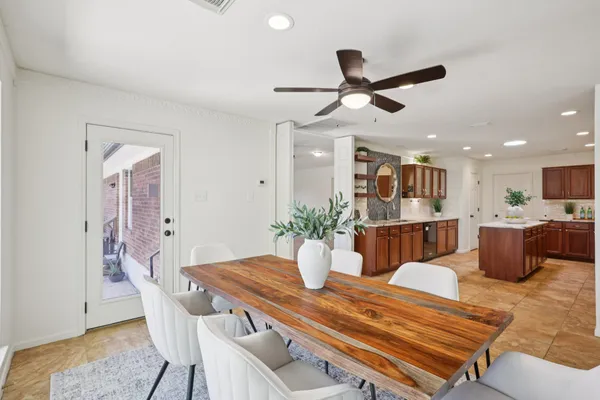 a dining room with furniture and view of kitchen