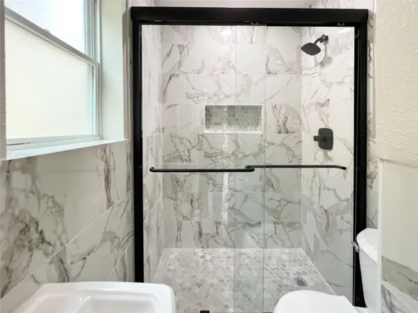 a bathroom with a bathtub and shower