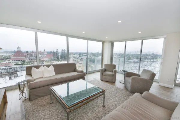 a living room with furniture and a floor to ceiling window