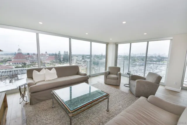 a living room with furniture and a floor to ceiling window