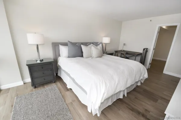 a large bed sitting in a bedroom next to a wooden floor