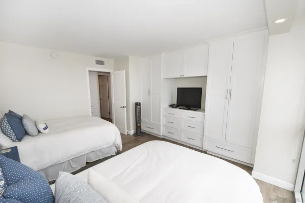 a bedroom with a bed and a flat screen tv