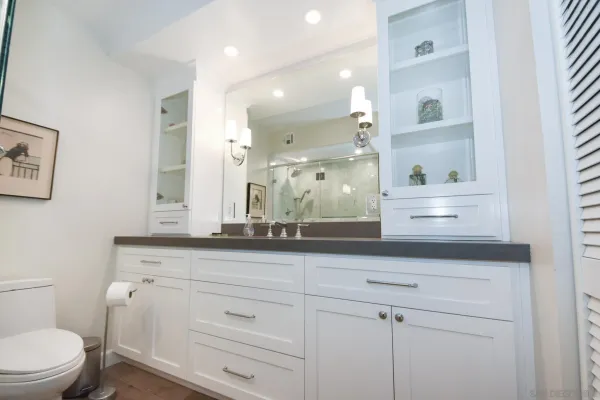 a bathroom with a sink a toilet and a mirror