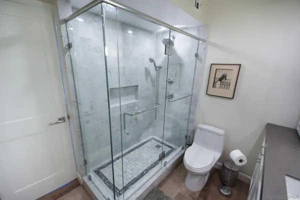 a bathroom with a toilet sink and shower