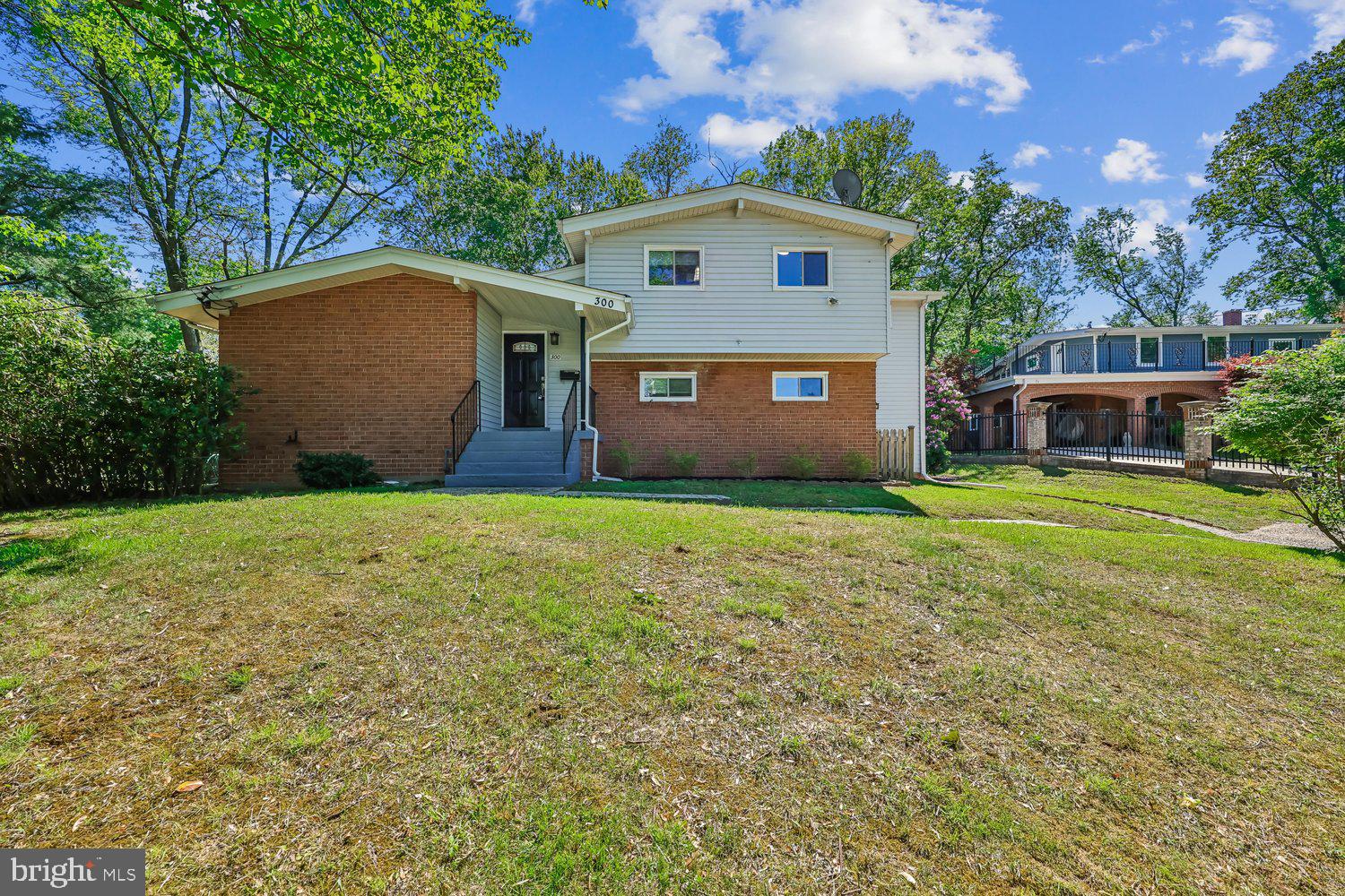 300 Gilsan Court Silver Spring, MD 20902 - Photo 9 of 117 a front view of house with yard and trees in the background