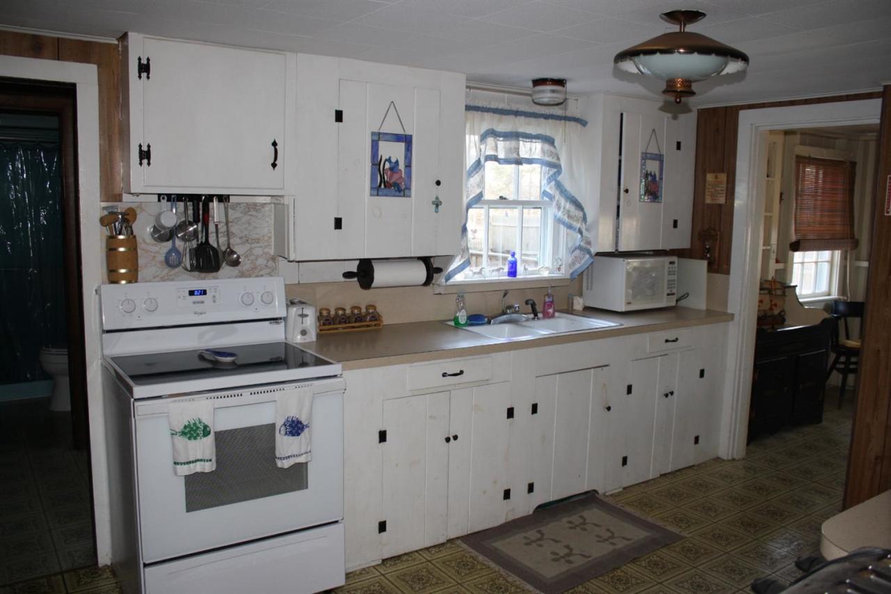 30 Longell Road Dennis Port, MA 02639 - Photo 12 of 19 a kitchen with cabinets appliances and a window