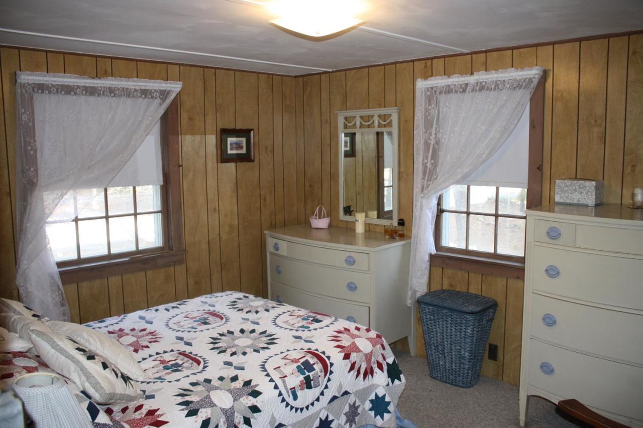 30 Longell Road Dennis Port, MA 02639 - Photo 6 of 19 a bedroom with a bed and a dresser next to a window