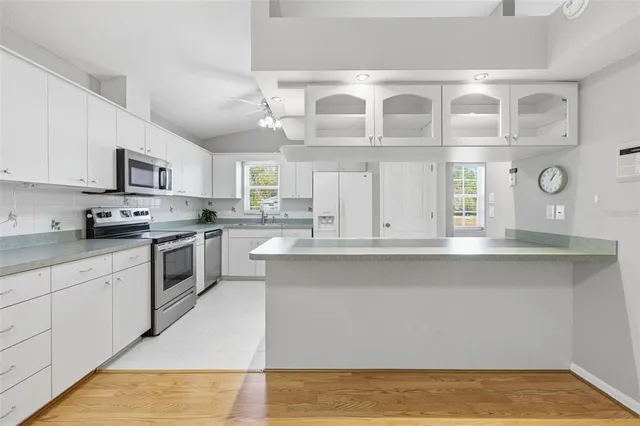 a kitchen with a sink stove and cabinets