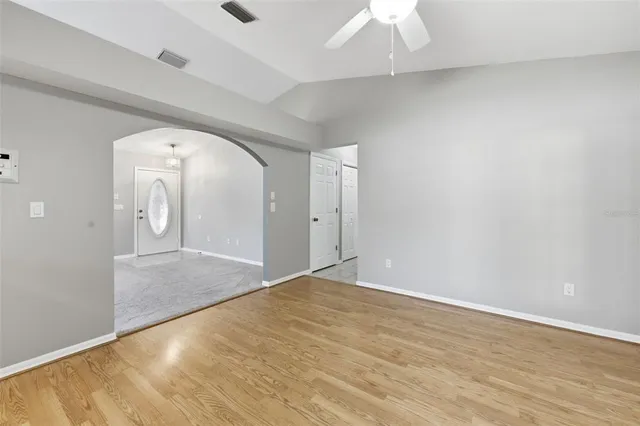 a kitchen with wooden floors and white appliances