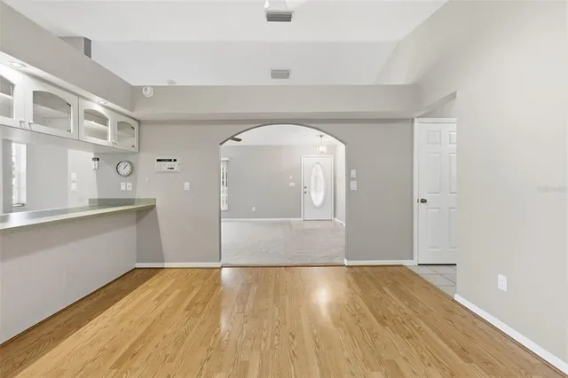 a view of a kitchen with wooden floor and a sink