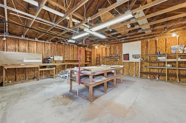 a yellow house with a big yard plants and large trees