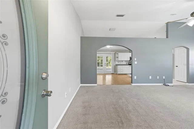 a living room with furniture a ceiling fan and a flat screen tv