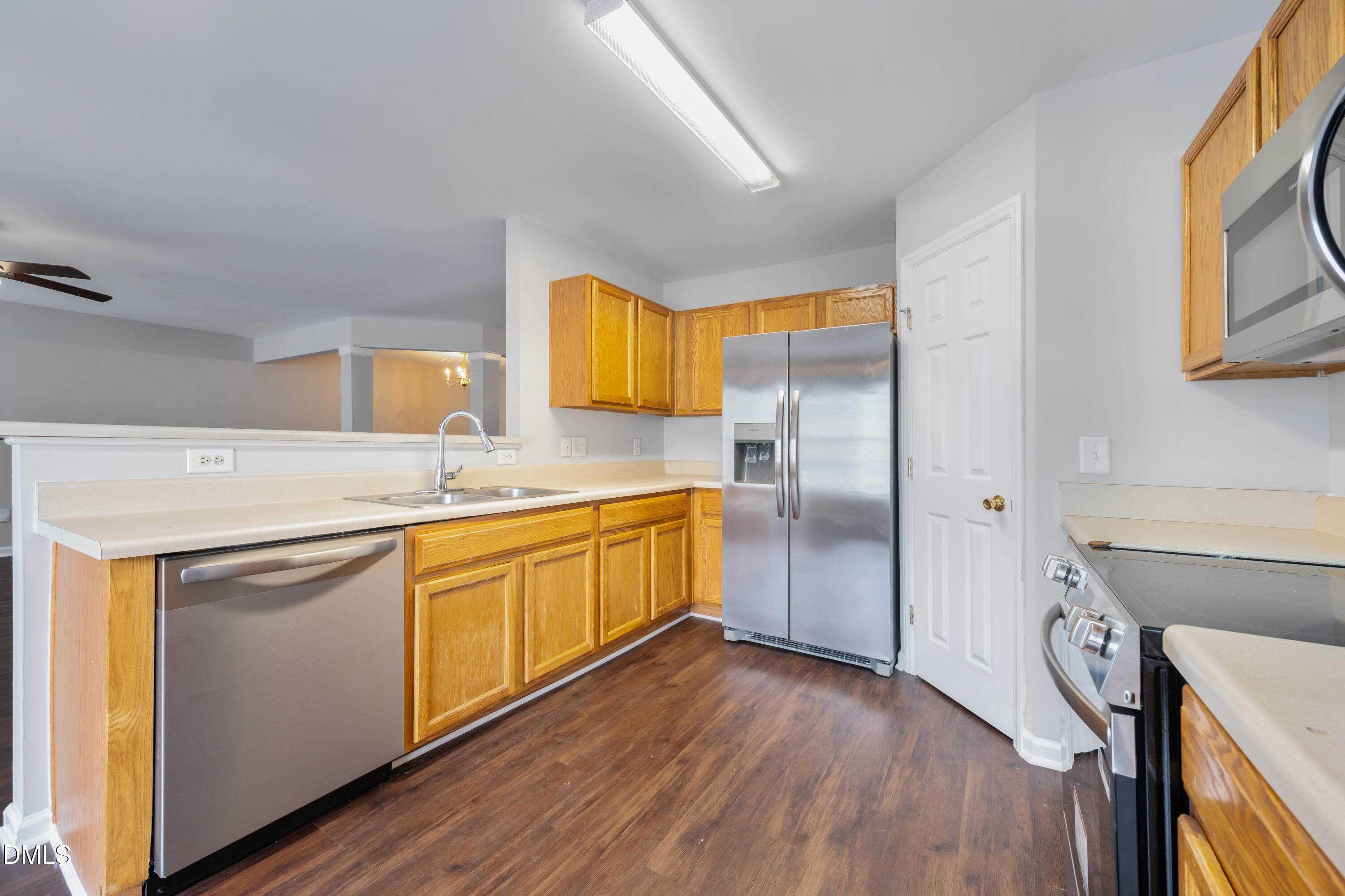 1532 Pebble Ridge Drive Raleigh, NC 27610 - Photo 17 of 40 a kitchen with stainless steel appliances granite countertop a refrigerator a sink dishwasher and wooden cabinets with wooden floor