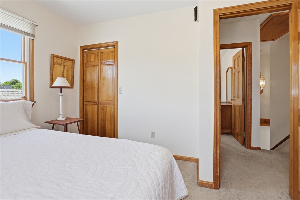 7 Swift Avenue Wareham, MA 02571 - Photo 25 of 42 a bedroom with a bed and a large mirror