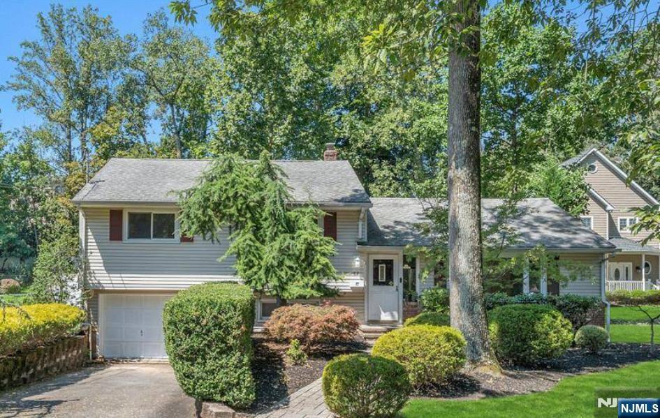 82 Little Falls Road Cedar Grove, NJ 07009 - Photo 1 of 36 a front view of a house with garden